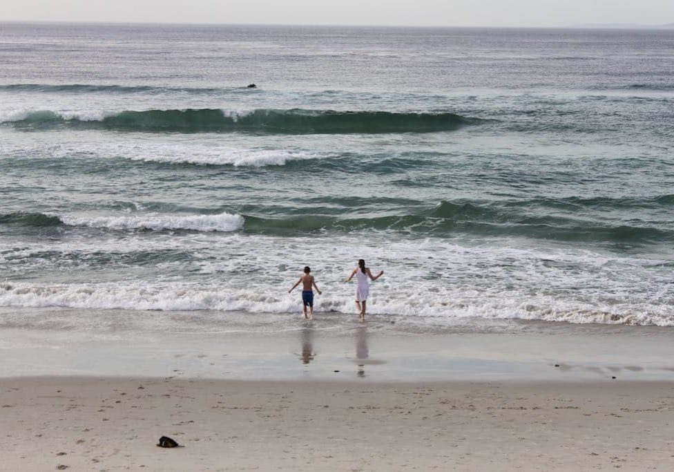 ...and 2 crazy British kids in the waves.